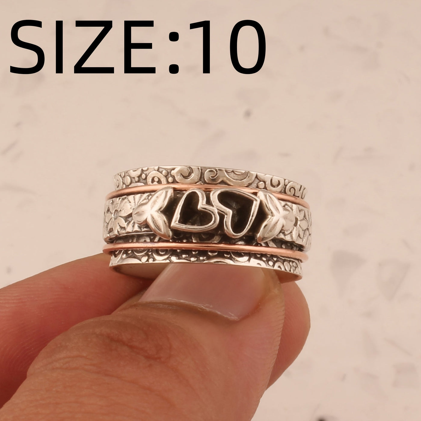 Zilveren spinner ring met hartjes en bloemen