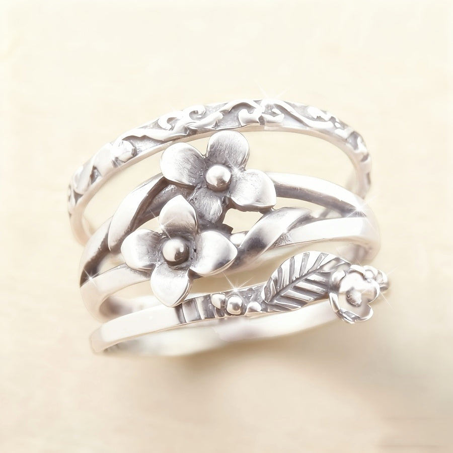 Zilveren ring met meerdere bloemen en bladeren