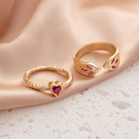 Gouden ringenset met slang en hart met roze zirkonia