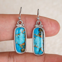 Zilveren oorbellen met rechthoekige turquoise steen