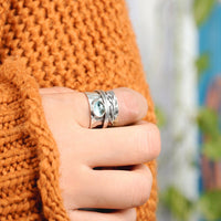 Zilveren spinner-ring met aquamarijn en bladmotief