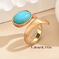 Gouden bypass ring met ovale turquoise steen