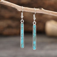 Zilveren oorbellen met langwerpige turquoise staaf