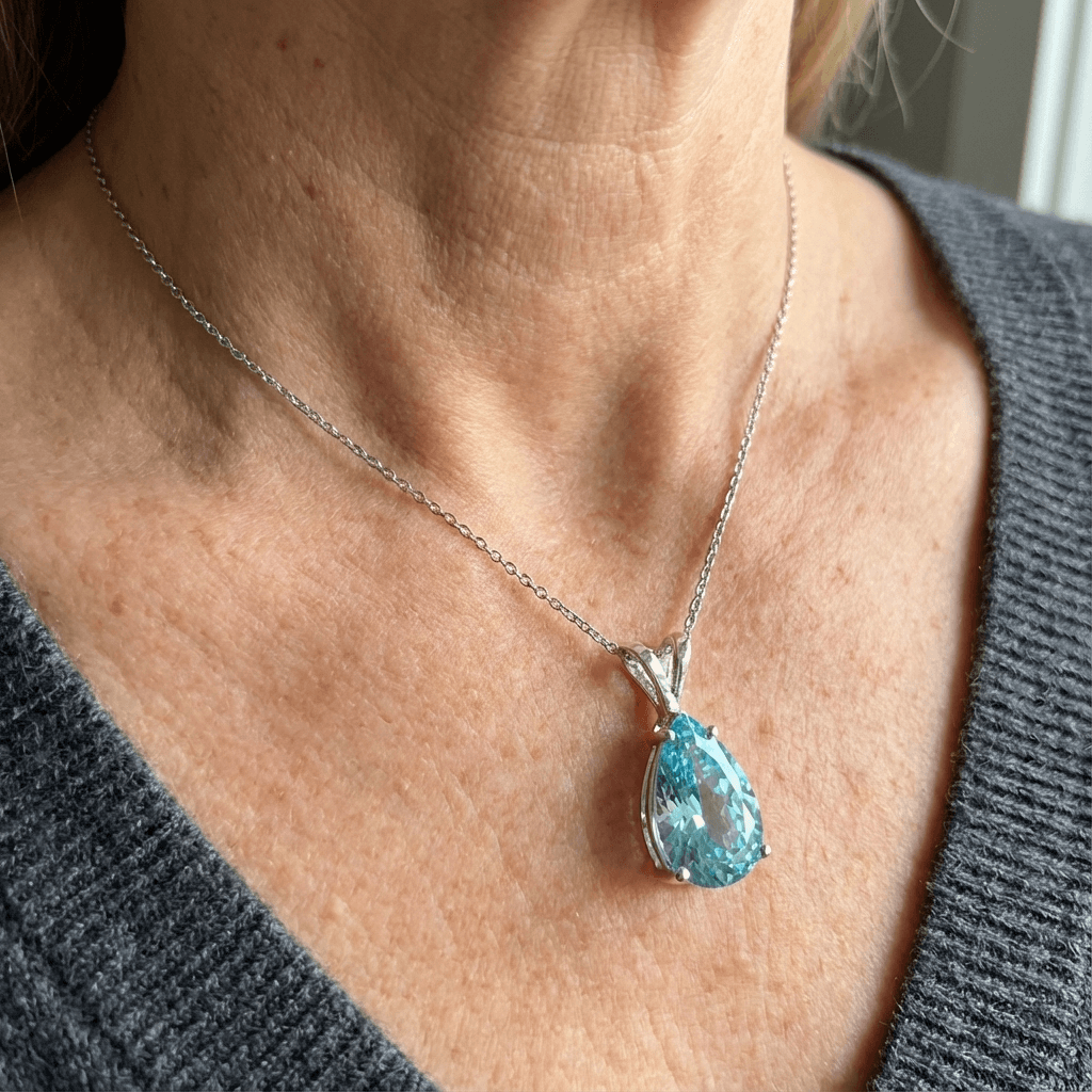 Gouden oorbellen met blauwe ovale edelsteen