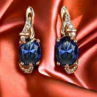 Zilveren ring met grote blauwe edelsteen en bladmotief