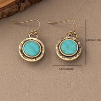 Goudkleurige vintage oorbellen met ronde turquoise