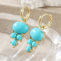 Gouden oorbellen met ovale turquoise en kraaltjes