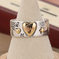 Zilveren ring met gouden hartjes en liefdesboodschap