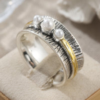 Zilveren ring met parels en goudkleurige spinner band