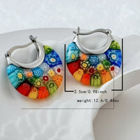 Zilveren hoepeloorbellen met kleurrijke millefiori glasbloemen