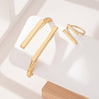 Gouden set met armband en ring met dubbele staaf