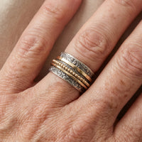 Zilveren en gouden spinner ring met sierlijk patroon