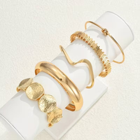 Gouden armbandenset met cuff en discs
