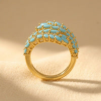 Gouden bypass ring met turkoois en zirkonia