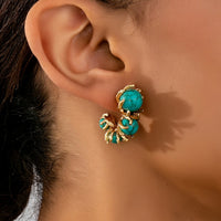 Gouden oorbellen met turquoise kralen