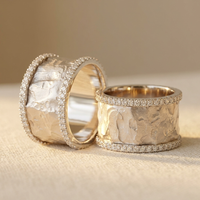 Brede gehamerde ringen in goud en zilver met zirkonia